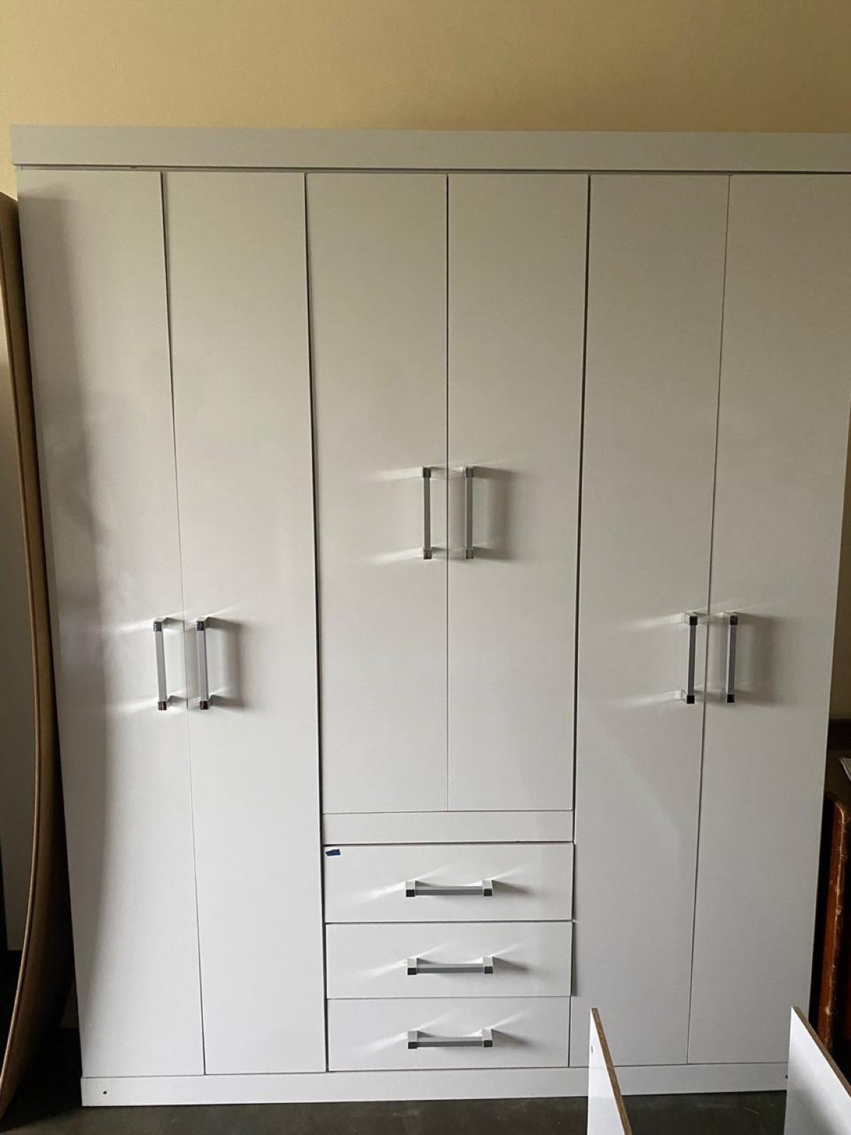 Built-in bedroom wardrobe with multiple doors and drawers inside a Tetelestai Recovery Centre residential room